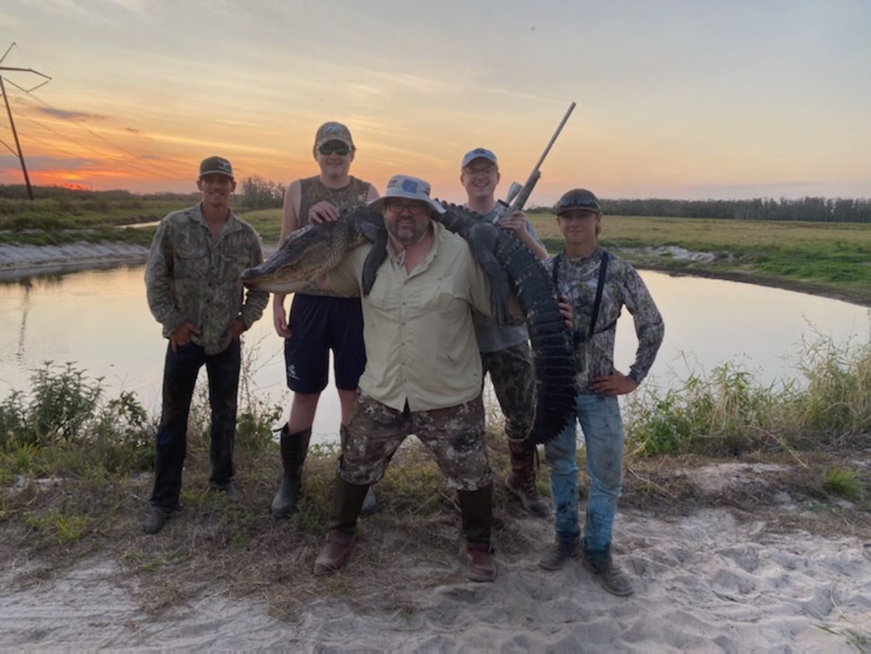 Group gator harvest at sunset